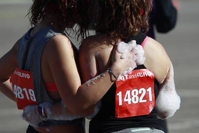 Participants pose for a photo after making their way through an obstacle during the Hit and Run 5k Saturday, March 1, 2014 at Sam Boyd Stadium. The Hit and Run 5k, a fun run with various obstacles to navigate, is being held or planned in two dozen cities across the country.